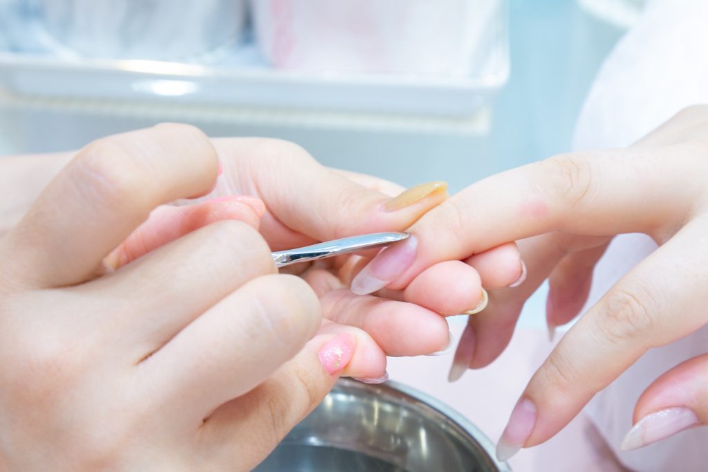 プッシャーを使用し甘皮を爪の根元にやさしく押し上げます